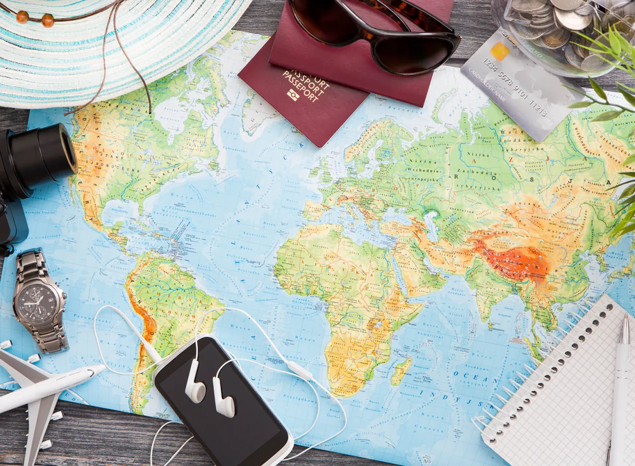 map passport camera toy aeroplane on table
